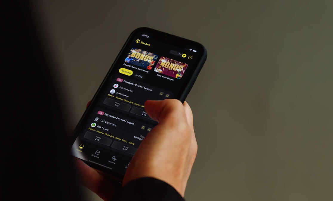 Hand holding a phone with BatAce app on the screen